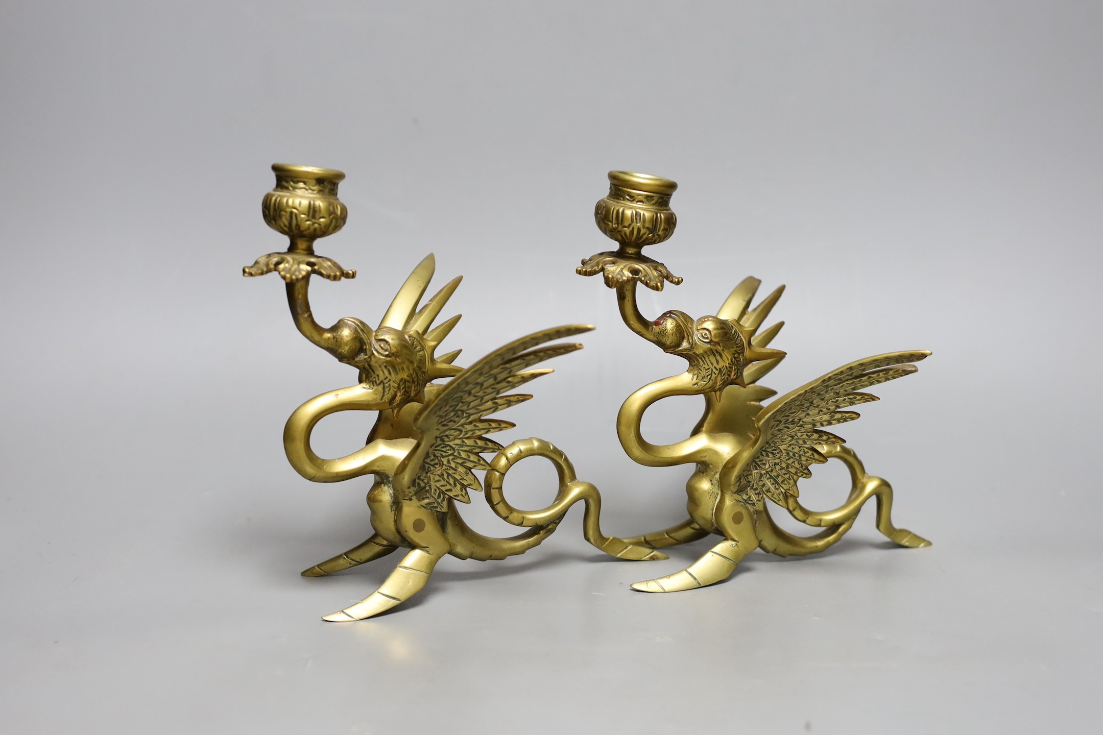 A pair of Griffin candlesticks, 19cm